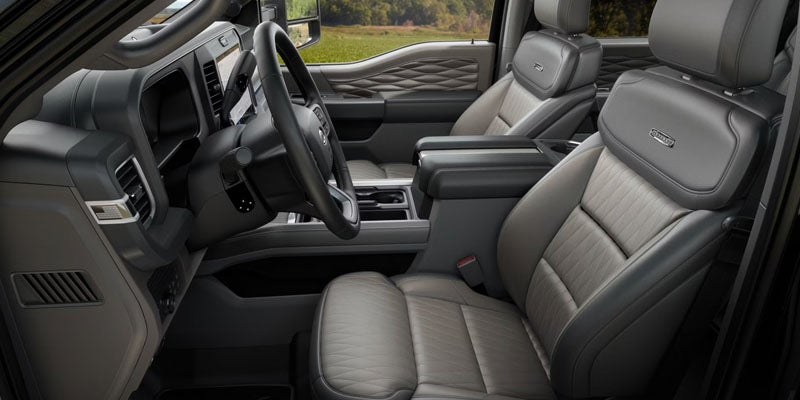 Interior of a Ford Super Duty showing leather front seats and dashboard.