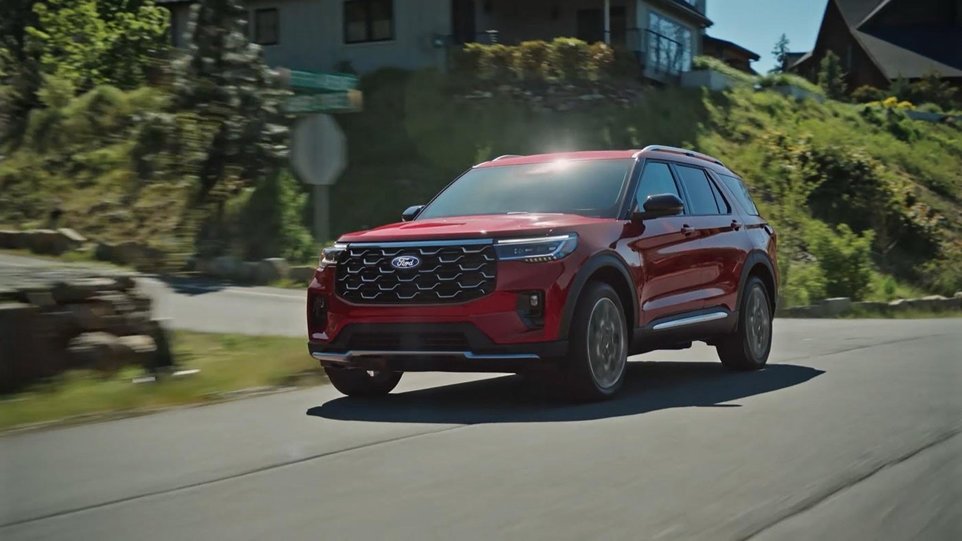 Ford Explorer Platinum SUV driving down a suburban street
