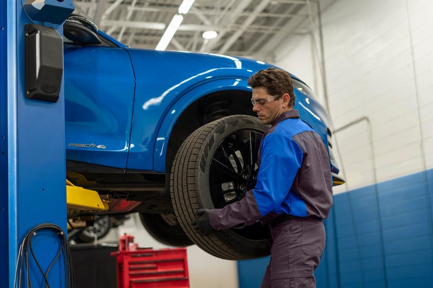 Ford Service technician removing a wheel from a vehicle