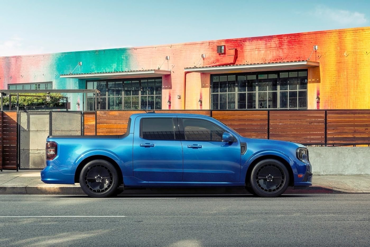 Blue Ford Maverick Lobo pickup parked in front of a colorful restaurant