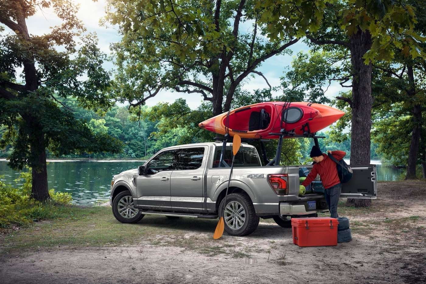 Ford owner getting a cooler from the bed of an F-150