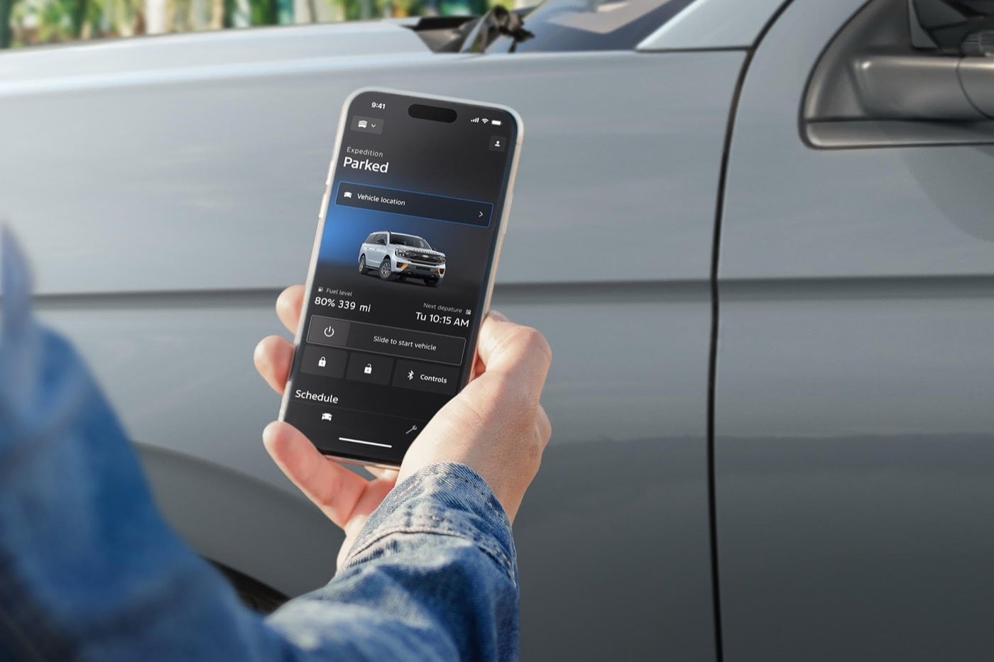 Person using remote features in the Ford app to access an Expedition